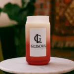 Lifestyle image of a GLISOVA candle on an outdoor table