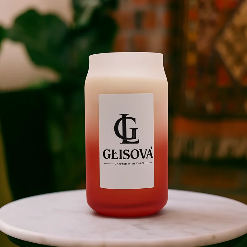 Lifestyle image of a GLISOVA candle on an outdoor table