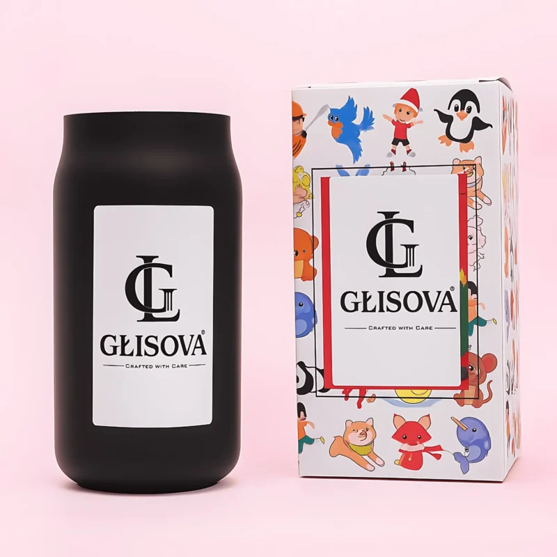 Artisan scented candle in a black vessel on a wooden desk