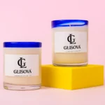 Hand-poured natural soy wax candle on a pink background