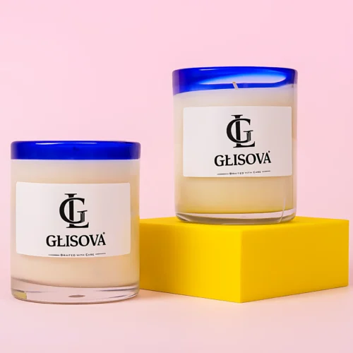 Hand-poured natural soy wax candle on a pink background