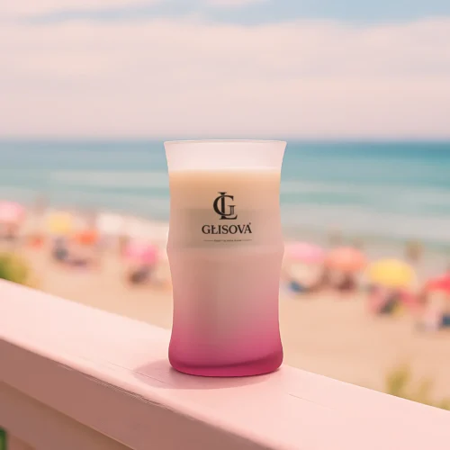 Luxury scented candle 'Desert Bloom' on a pink table in a vibrant patio setting