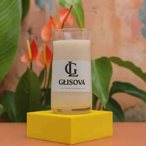 Luxury scented candle 'Temple Whisper' on a pink ceramic dish