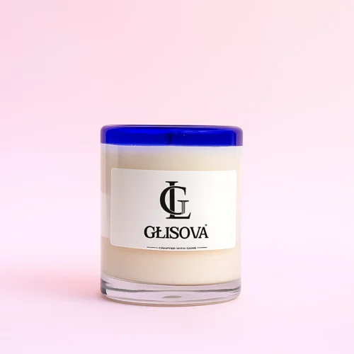 GLISOVA artisan candle with a blue rim in a home setting.